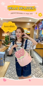 Detail of cute watermelon-shaped backpack with pink fabric and fruit seed embroidery