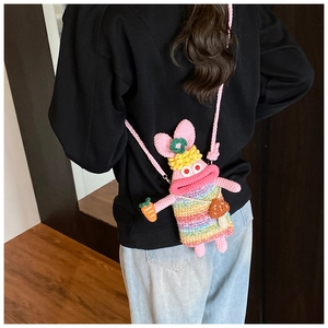 Handmade crochet bunny shoulder bag featuring a quirky pink rabbit with rainbow stripes