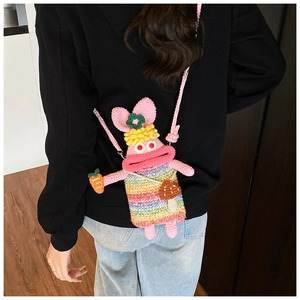 Detailed view of handmade pink crochet crossbody bag with funny large lips and rainbow stripes
