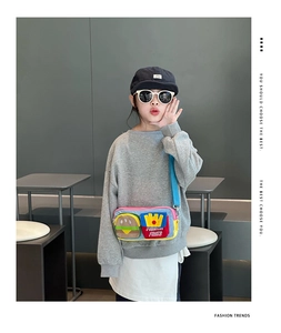 Detail of child wearing a crossbody bag with cute hamburger and french fries design