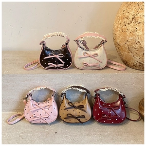 Polka dot children handbags with lace handles and bow details in five soft colors