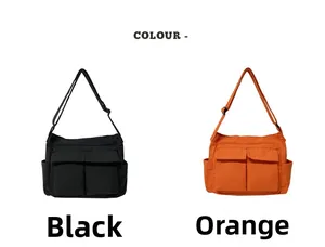 Detail of canvas tote bags in black and orange showing large pockets and wide straps