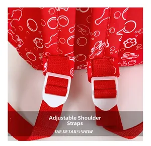 Close-up of adjustable red shoulder straps on kids backpack with cartoon lobster prints