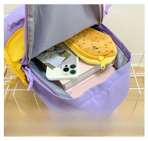 Detail showing the large interior capacity of this purple and yellow canvas kids backpack