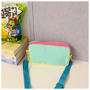 Close-up of a multicolor nylon kids crossbody bag featuring pink zipper and metal hooks