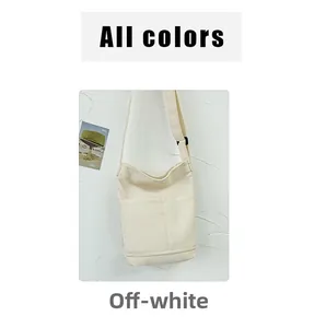Detail of minimalist beige canvas shoulder bag with adjustable strap and outer pocket