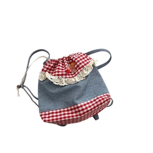 Japanese style drawstring backpack with navy denim, red plaid, and beige lace trim