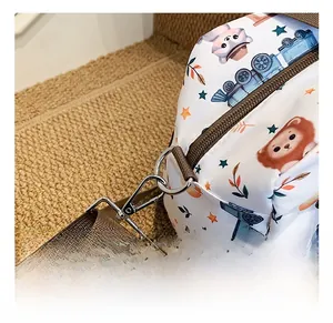 Detail of silver metal swivel hook and brown nylon strap on a cartoon animal print bag