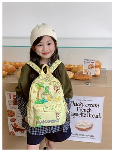 Detail of yellow kids backpack with cartoon monkey and banana patterns in bakery setting