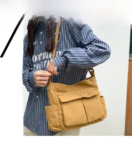 Detail of a ginger canvas tote bag with front flap pockets and adjustable shoulder strap