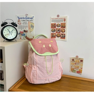Detail of pink kids backpack with watermelon pattern lid and HELLO embroidery