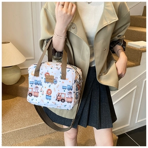 Detailed view of canvas tote bag with cute animal prints and adjustable brown straps
