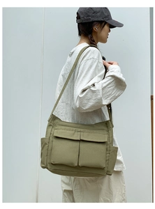 Detail of army green canvas tote with dual front flap pockets and spacious side compartment