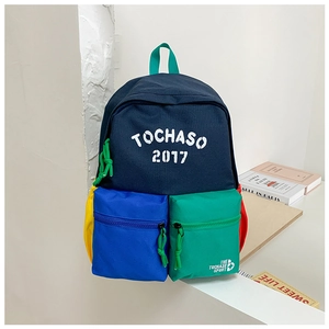 Close-up of colorful school backpack featuring double front pockets and varsity letters