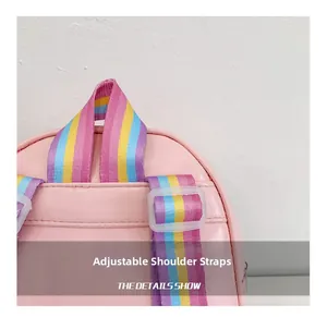 Detail of colorful rainbow woven shoulder strap with white adjustable buckle on a pink backpack