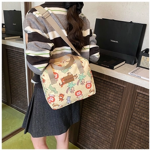 Detail of cartoon animal canvas crossbody bag with adjustable strap and leather logo tag