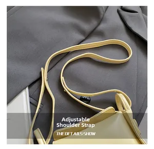 Detail of adjustable shoulder strap on minimalist pale yellow PU leather kids crossbody bag