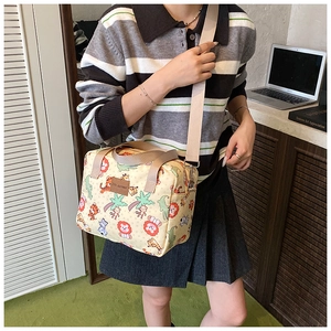 Detail of canvas bag featuring colorful cartoon animals and durable shoulder strap