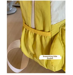 Detail of yellow school backpack showing elastic side pocket for water bottle and umbrella