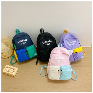 Detail view of colorful contrast school backpacks in navy, black, purple, and pink colors