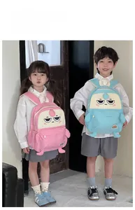 Detail view of pink and blue cartoon backpacks with 3D decorative arms and legs