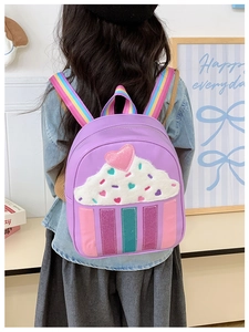 Detail view of purple kids backpack with 3D plush cupcake and rainbow straps