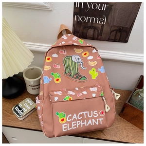 Detail of pink cartoon elephant backpack with cactus prints on a cozy wooden desk