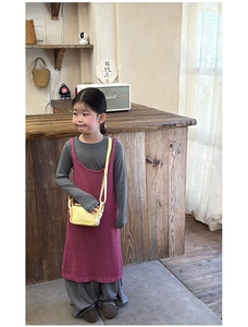Detail showing knit vest dress set with wide-leg pants and a yellow mini crossbody bag
