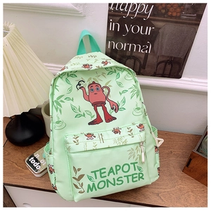 Detail of light green school bag featuring a teapot monster cartoon and spacious pockets