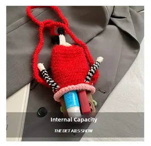 Detail view of the red crochet crossbody bag showing interior capacity for phone and cosmetics