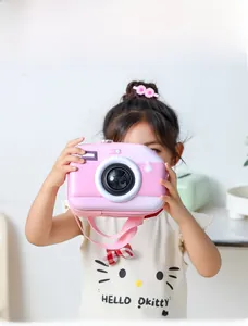 Detail shot of a pink camera-shaped crossbody bag worn by a child with adjustable strap