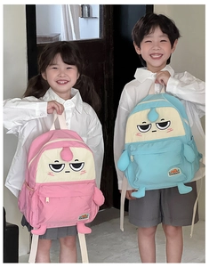 Detail of pink and light blue cartoon backpacks with cute soft limbs for kids