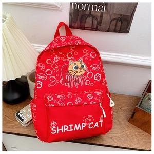 Detail of red cartoon backpack featuring unique shrimp cat print and front zipper pocket