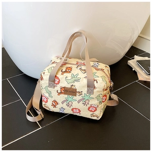 Detail of cute animal print storage bag with khaki handles and brand leather label
