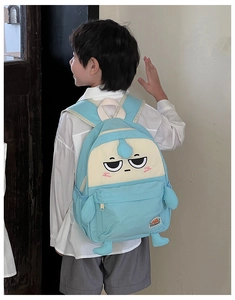 Detail of blue cartoon backpack with 3D elements on boy model back view