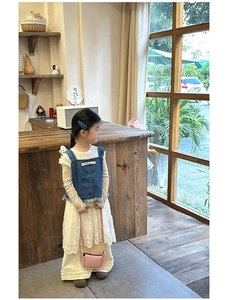 Detail of vintage style kids denim vest with lace dress and pink crossbody bag combo