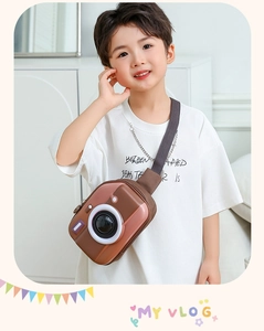 Detail of creative brown camera-shaped EVA kids crossbody bag with 3D lens and grey strap