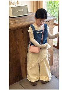 Close-up of pink leather crossbody mini bag for girls with thin shoulder strap detail