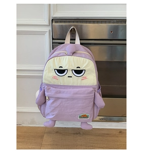 Detail of cute purple cartoon backpack with embroidered eyes and 3D plush limbs