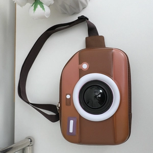 Close-up of creative camera-shaped hard shell chest bag for kids with adjustable strap