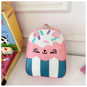Close-up of pink cat cupcake kids backpack with glitter ears and rainbow embroidery