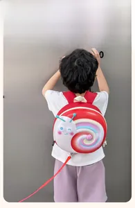 Toddler safety backpack with cartoon snail design and red anti-lost traction rope detail