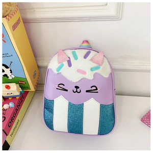 Macro detail of toddler backpack featuring cupcake cat design and colorful sequin textures