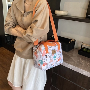 Cartoon dinosaur print lunch bag with orange straps and versatile crossbody design
