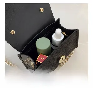 Internal capacity of mini black sequin handbag with gold chain strap and cosmetics
