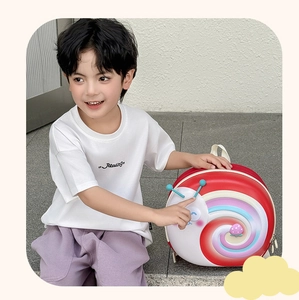 Detail of red snail hard shell backpack featuring a colorful rainbow swirl design