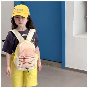 Kid back view showing the pink and cream drawstring backpack with wide shoulder straps