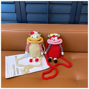 Detailed view of handmade crochet monster bags for kids in beige and red colors