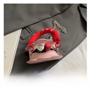 Detailed view showing the interior capacity of the mini pink heart cloud bag with lipstick