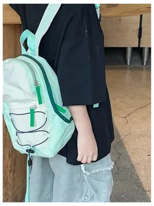 Detail of mint green and white drawstring kids backpack with adjustable straps